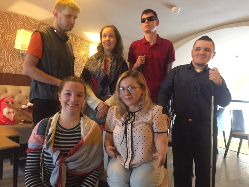 Laurel standing with 3 deafblind men who received canes. Also pictured are Laurel's friend Amy and Alina who served as their interpreter.