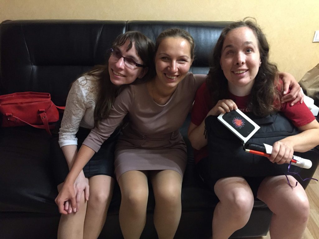 Laurel presents an iPhone and cane to Elena F. in Moscow. Alyona is also pictured.