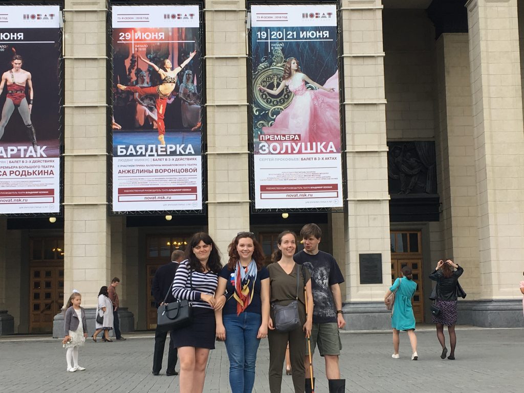 Laurel and Amy are in Novosibirsk, the capital of Siberia with Aleksey and Olga who received technology. They are standing in front of the city theatre.