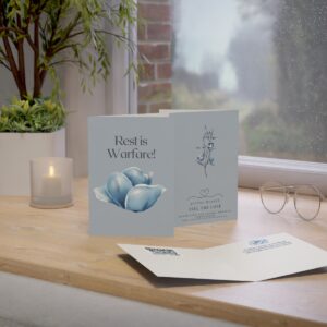 Rest Is Warfare card displayed on a table top showing the cover, back and interior of the card